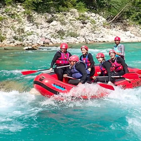 A raft dropping through whitewater on the Soca