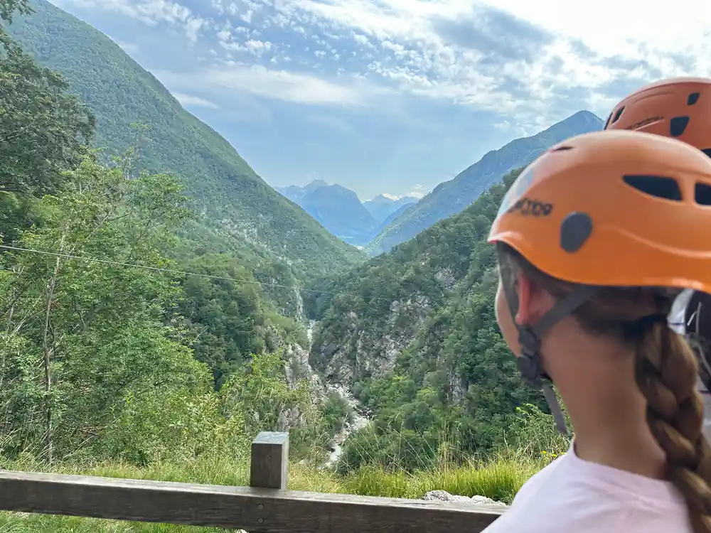 A helmet and the valley beyond the platform rail