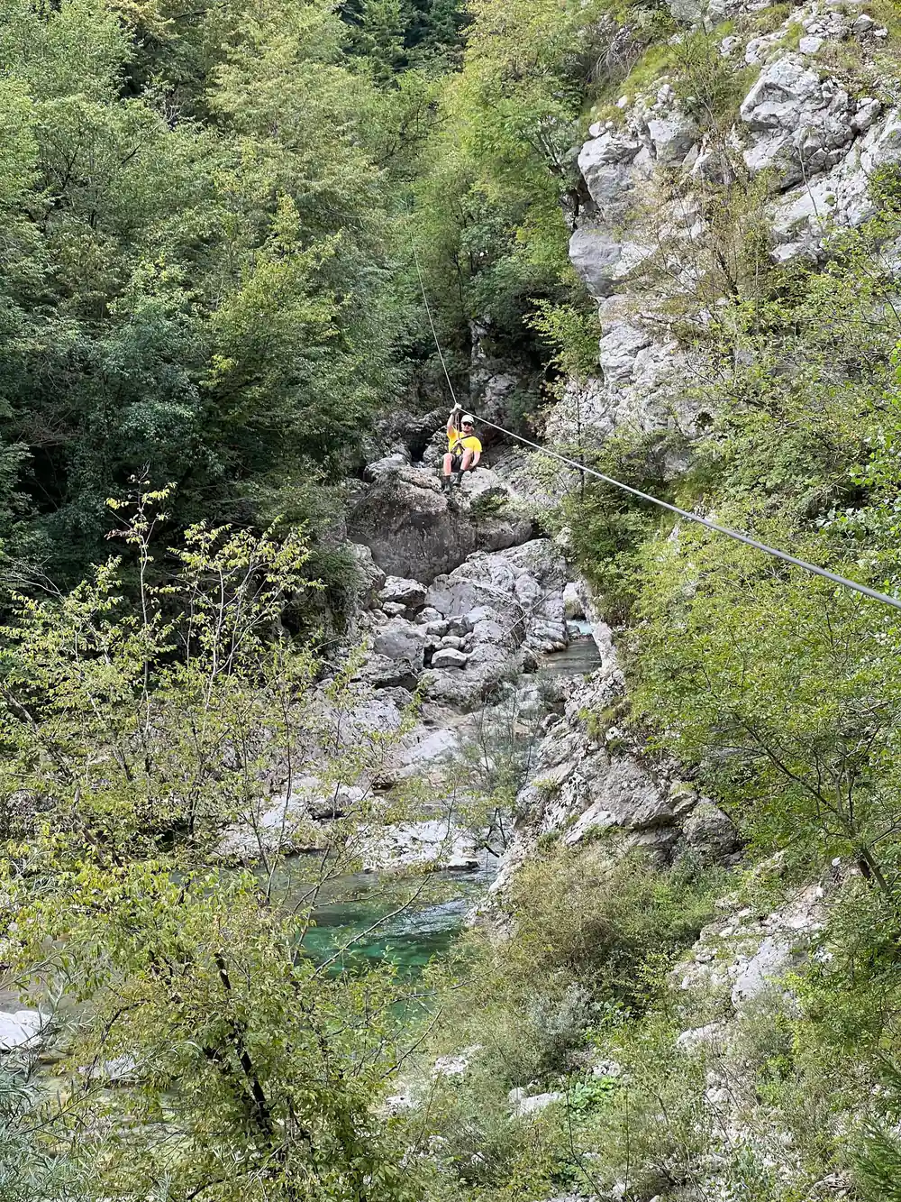 A rider small against the rock walls of the canyon