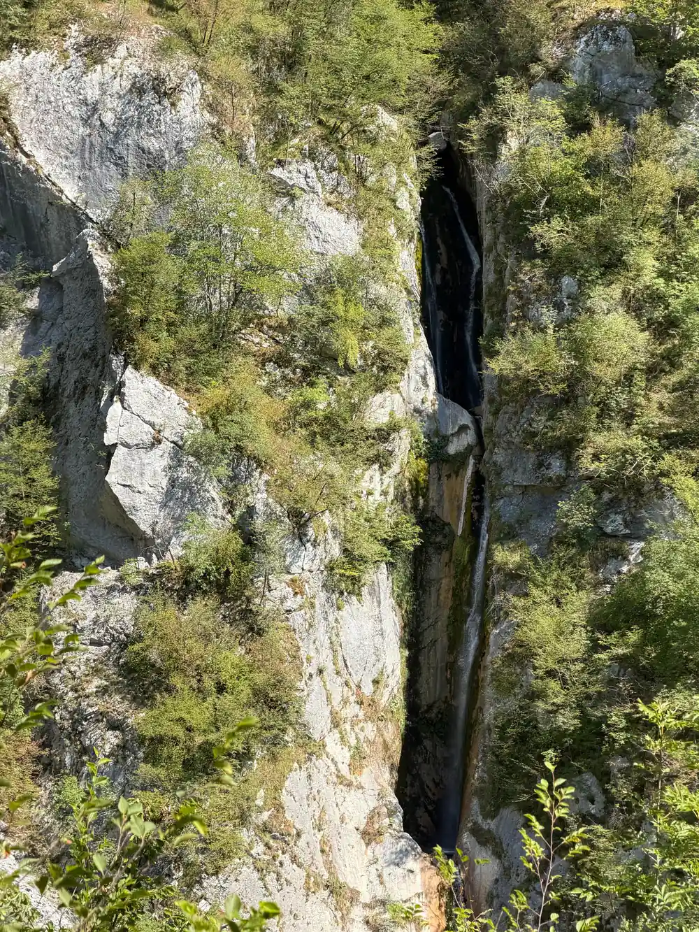 A waterfall dropping into the canyon