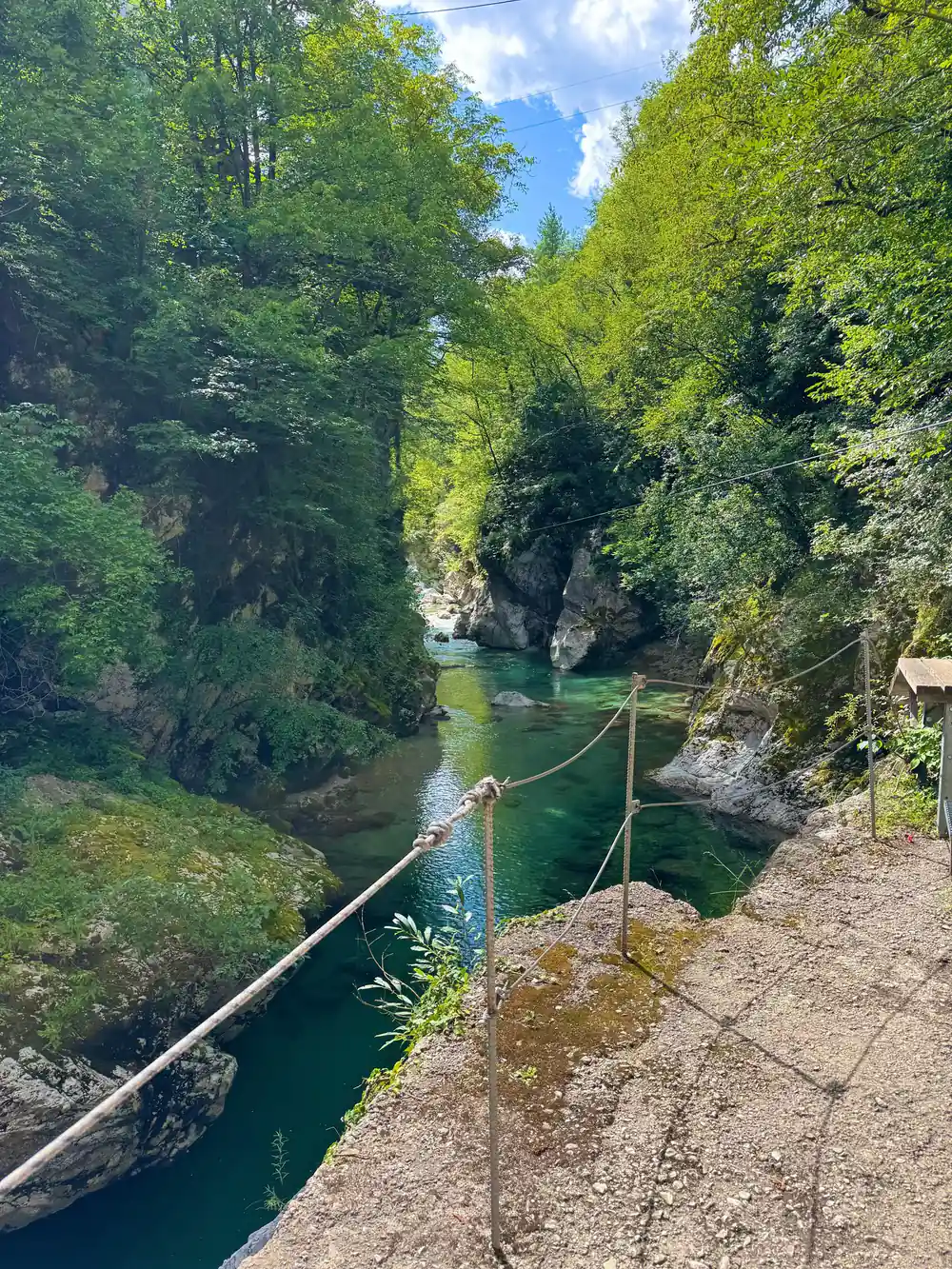 A wire strung across the water far below
